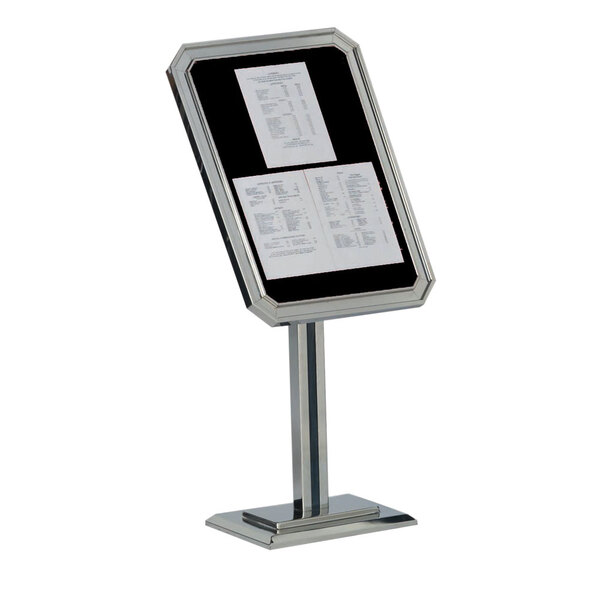 A chrome and black Aarco pedestal sign stand with papers on it.