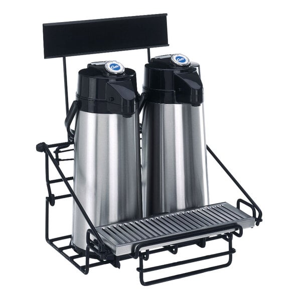 A black wire rack holding two Curtis stainless steel coffee airpots.