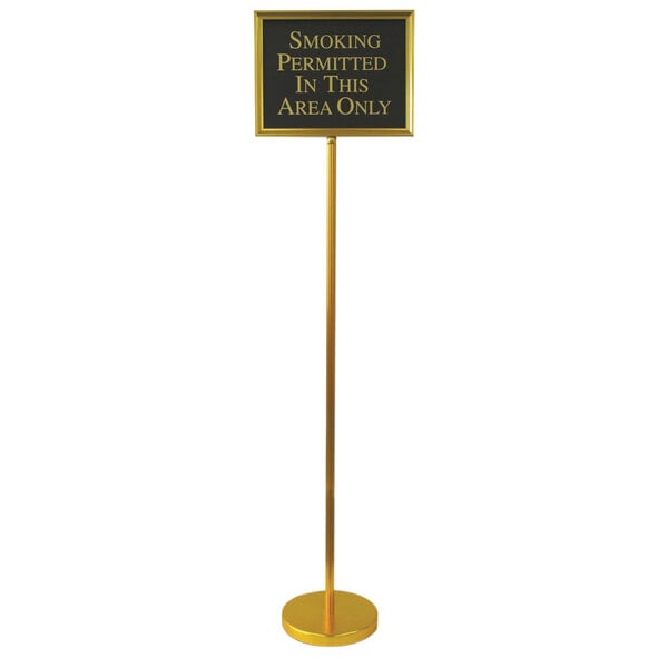 A gold aluminum Aarco hostess/teller sign on a long thin gold pole.