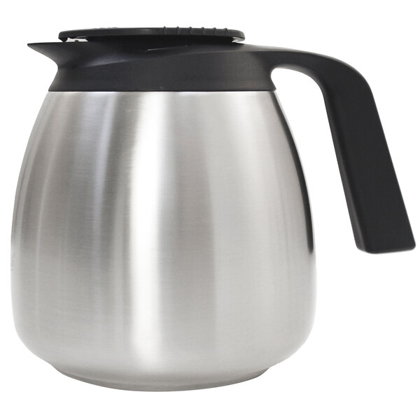 A silver stainless steel Curtis coffee server with a black handle.
