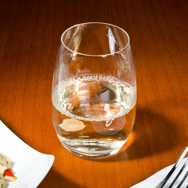 A table set with a fork and a Stolzle stemless wine glass.