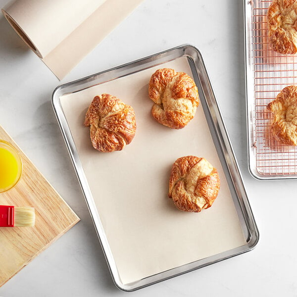 A Baker's Mark PanPal pan liner on a baking tray with croissants.