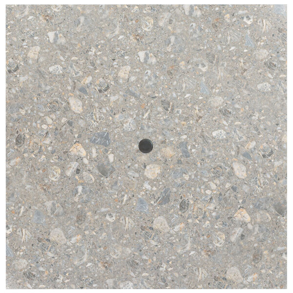 A grey stone table top with a black circle in the center.