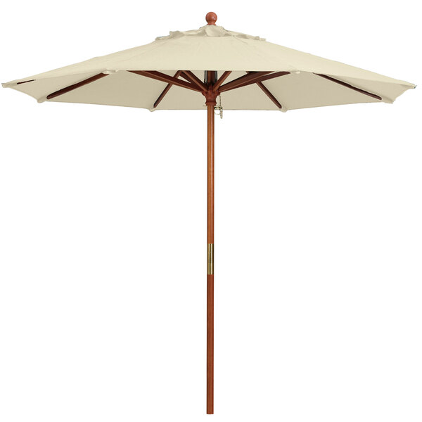 A white Grosfillex market umbrella with a wooden pole.