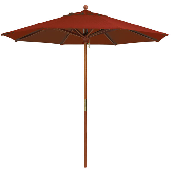 A Grosfillex red umbrella with a wooden pole.