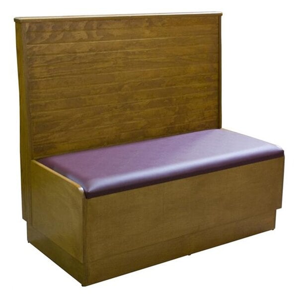 An American Tables & Seating wooden booth with a purple bead board back and seat.