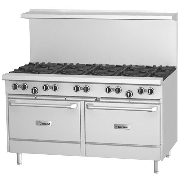 A large stainless steel Garland gas range with a griddle and two convection ovens and black knobs.