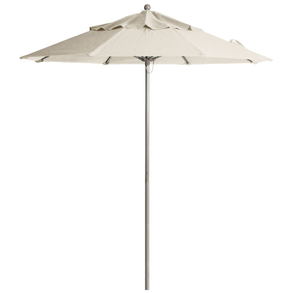 A white Grosfillex Windmaster umbrella on a metal pole.