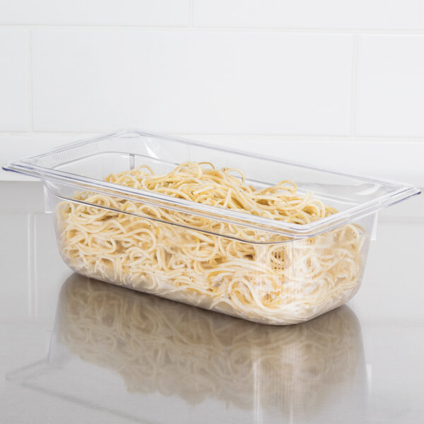 A Vollrath 1/3 size clear polycarbonate food pan filled with noodles.