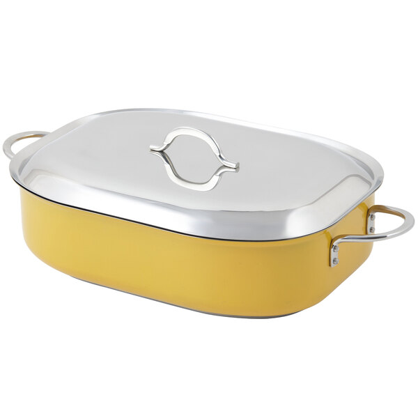 A yellow and stainless steel Bon Chef French oven with lid.