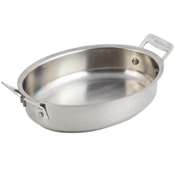A stainless steel Bon Chef oval au gratin pan with handles.