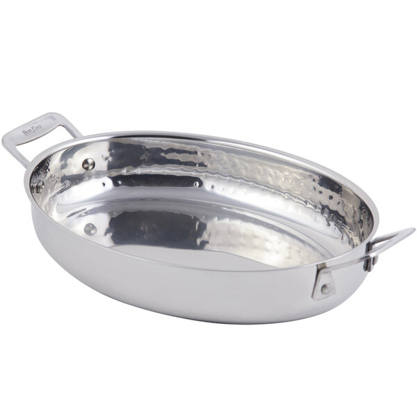 A silver stainless steel oval pan with wavy edges and handles.