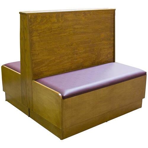 An American Tables & Seating wooden booth with purple cushions on the seats.