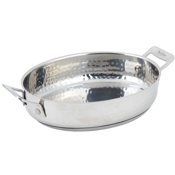 A Bon Chef stainless steel oval au gratin dish with a hammered finish and handles.