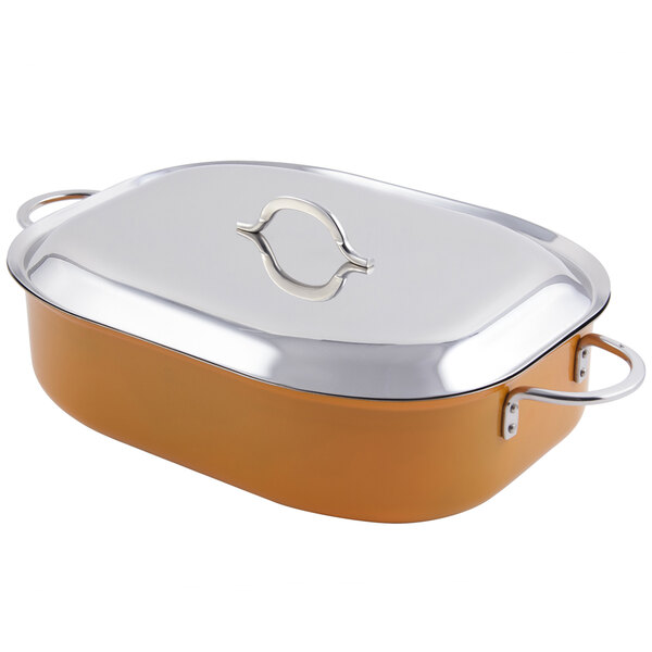 An orange Bon Chef oval French oven with a stainless steel lid and handles.
