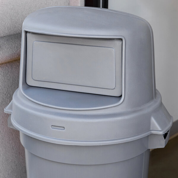 A Continental gray round dome top lid on a trash can.