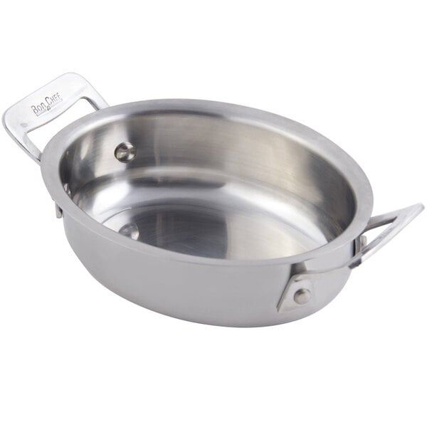 A stainless steel Bon Chef oval dish with two handles.