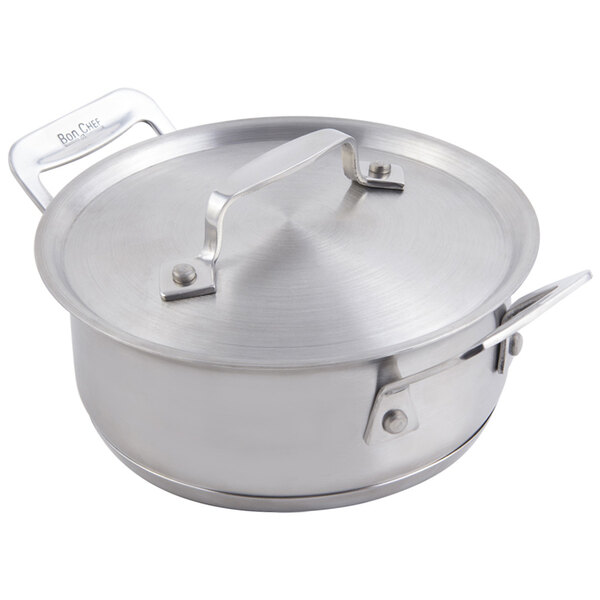 A silver stainless steel Bon Chef Cucina pan with lid and metal handle.