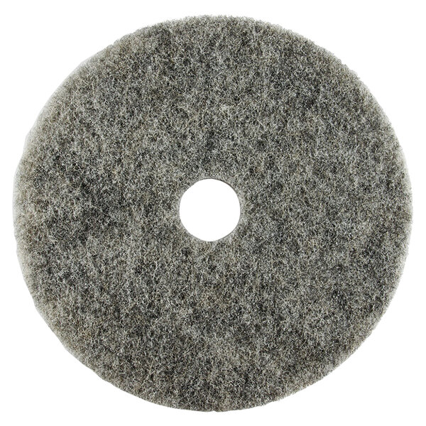 A grey circular Scrubble light burnishing floor pad with a hole in the middle.