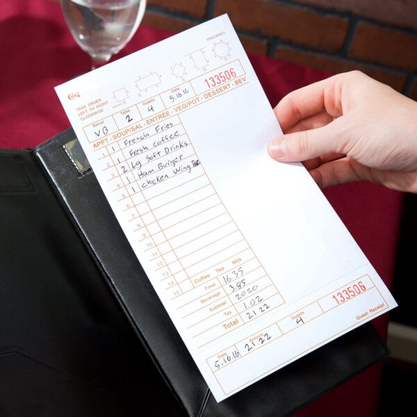 A hand holding a Choice tan and white guest check receipt with beverage lines and note space.