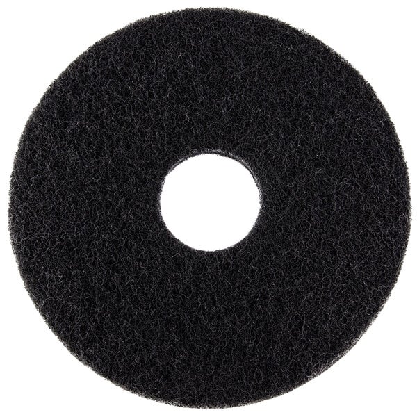 A black circular Scrubble stripping floor pad with a hole in the middle.