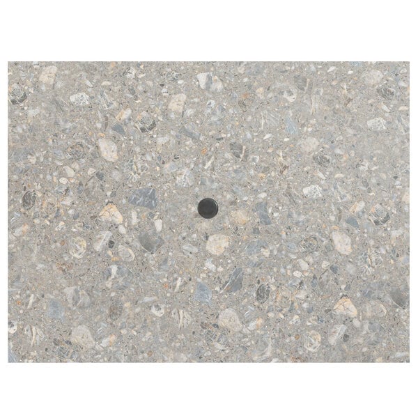 A Grosfillex Tokyo Stone rectangular table top with an umbrella hole in the center.