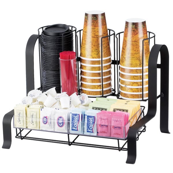 A black Cal-Mil metal coffee condiment organizer holding a variety of condiments with cups and sugar packets.