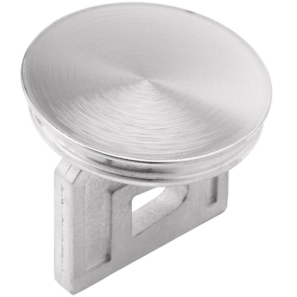 A silver metal circular knob for a drain valve.