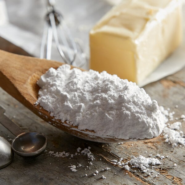 A spoonful of 10X confectioners sugar with a metal ladle.