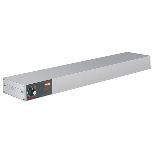 A rectangular metal Hatco food warmer with a red glow on a stainless steel shelf.