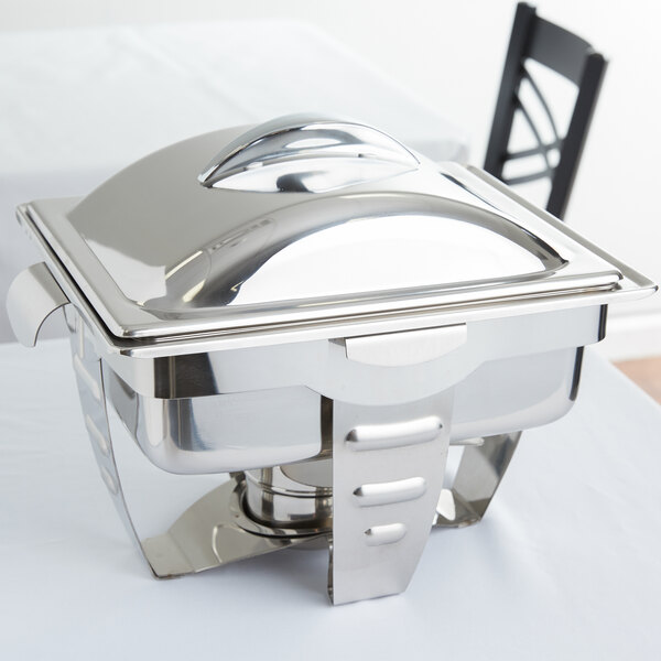 A silver Vollrath Maximillian rectangular chafer with stainless steel accents on a table.