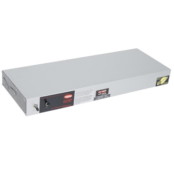 A white rectangular metal box with a black label and red lights.
