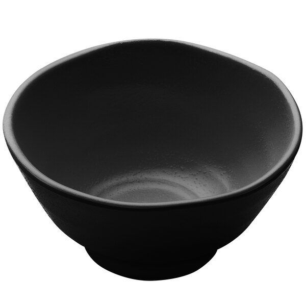 A close up of a black Elite Global Solutions Zen melamine bowl on a white surface.