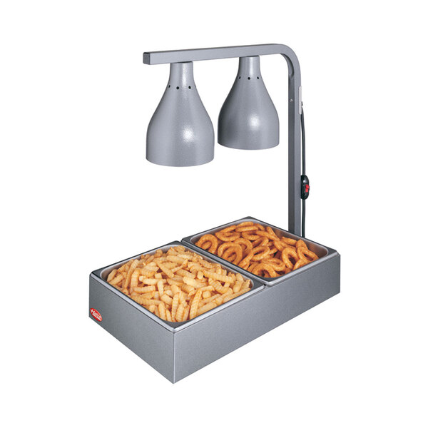 A Hatco countertop food warmer with two trays of french fries and onion rings.
