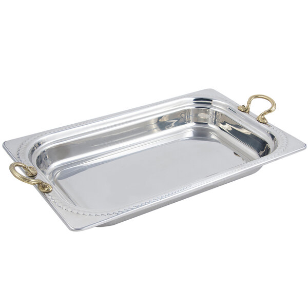 A rectangular silver food pan with round brass handles.