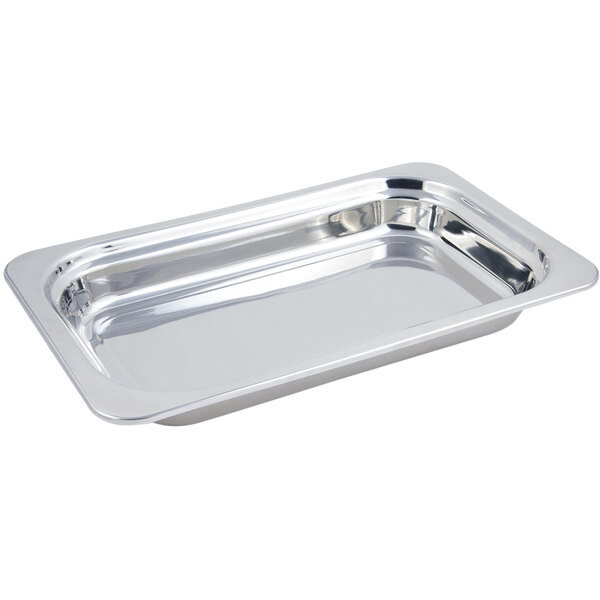 A stainless steel rectangular food pan with round brass handles.