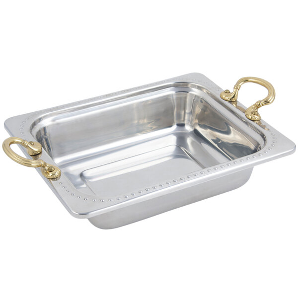 A stainless steel rectangular food pan with brass handles.