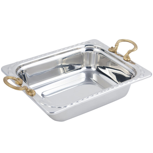 A stainless steel rectangular food pan with brass handles in an arches design.