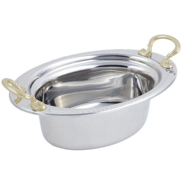 A stainless steel Bon Chef oval food pan with round brass handles.
