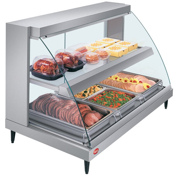 A Hatco countertop heated display case with curved glass shelves holding different types of food.