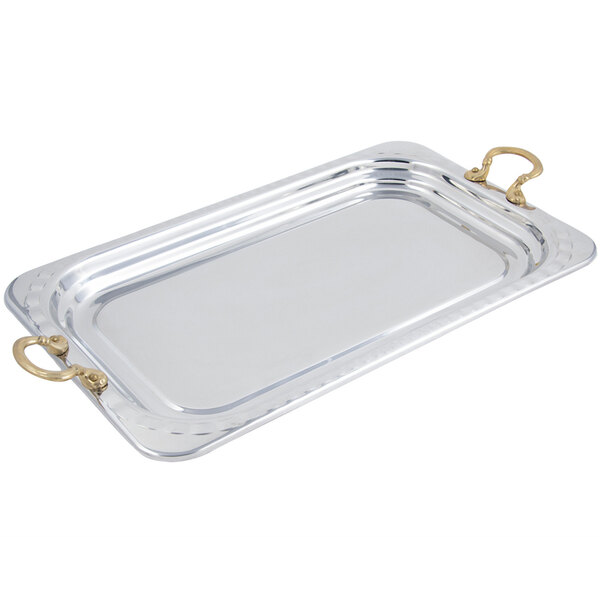 A silver rectangular Bon Chef food pan with arched design and round brass handles.