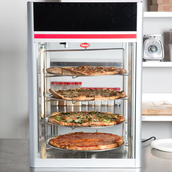 A Hatco Flav-R-Savor pizza display case with a circle rack holding pizzas.