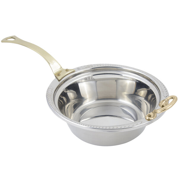 A Bon Chef stainless steel casserole food pan with a long brass handle decorated with a laurel design.