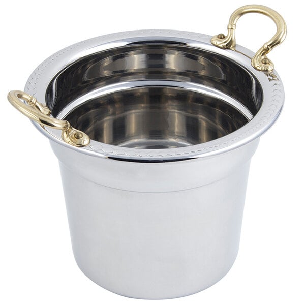 A stainless steel Bon Chef soup tureen with round brass handles.