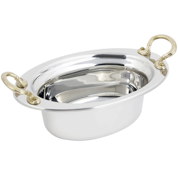 A stainless steel Bon Chef oval food pan with round brass handles.