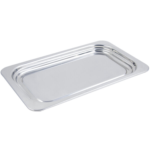 A Bon Chef stainless steel rectangular food pan with a plain design on a counter.