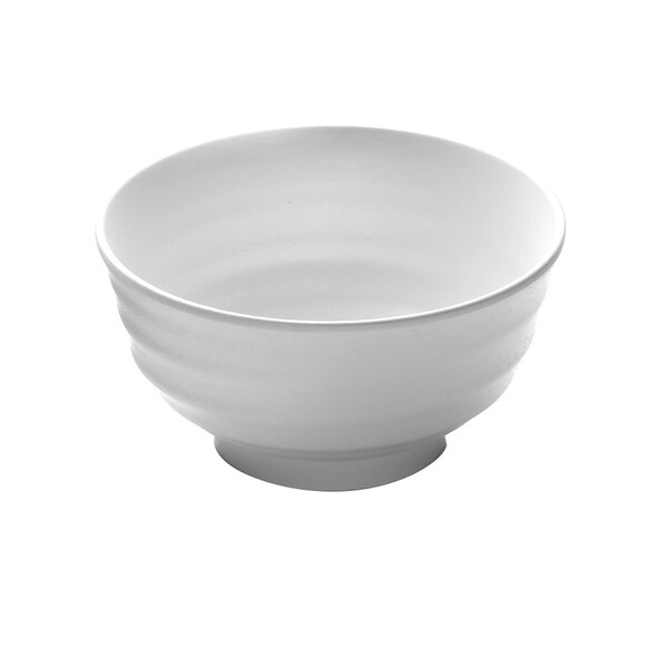A white Elite Global Solutions melamine bowl with a curved edge.