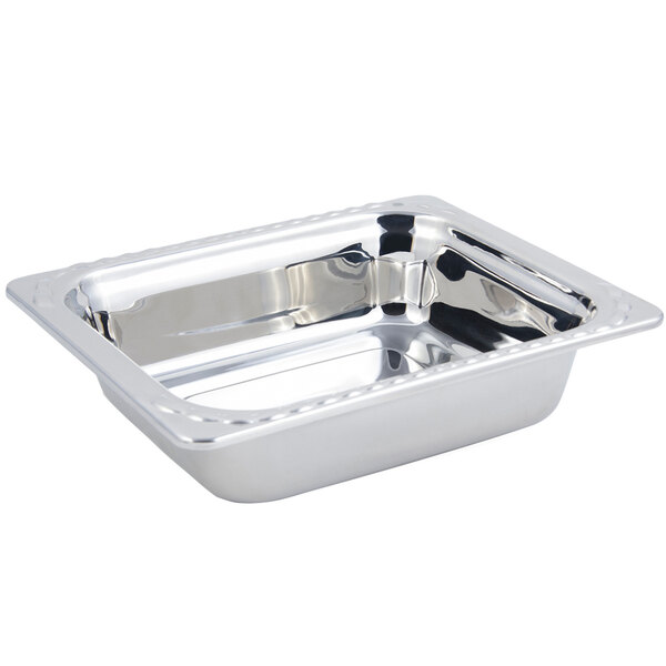 A stainless steel rectangular food pan with an arches design on a counter.