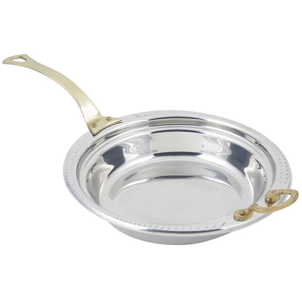 A stainless steel Bon Chef casserole food pan with a laurel design and a long brass handle.