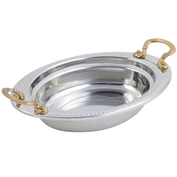A silver food pan with a Laurel design and round brass handles.